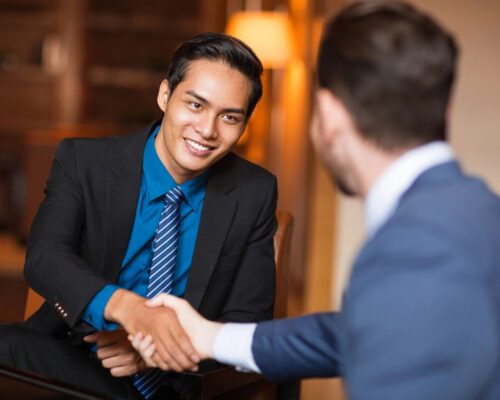 Two men in business attire shaking hands. supervision of supervision in North Carolina can support you. Learn more from a clinical supervisor in Texas.